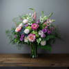 Mixed pink, purple, and white bouquet in a glass vase