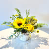 Sunflower and yellow rose arrangement in a white ribbed vase