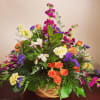Colorful mixed flower arrangement in a woven basket