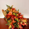 Autumn bouquet with orange roses and yellow daisy-like flowers
