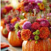 Colorful flower arrangement in a carved pumpkin vase