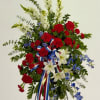 Red, white, and blue floral standing spray with ribbon accents