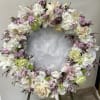 Heart-shaped floral wreath with white, blush, and lavender flowers