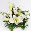 White lilies and roses arranged in a white basket