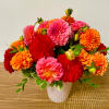 Bright mixed dahlia bouquet in a white vase