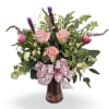 Select this sweet garden-style arrangement featuring soft pink roses, playful blooms, and