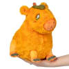 Orange plush cow with a pumpkin on its head, held in a hand