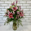 Gathering vase filled with Stargazer lilies. One of our most popular items!