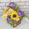Purple and yellow flowers arranged in a brown box