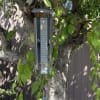 Butterfly-themed wind chime hanging from a tree branch