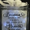 Lighted glass block with white feathers, ribbon, and a memorial quote about a loved one in heaven.