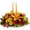 Autumn floral centerpiece with two orange candles