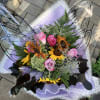 Send something uniquely beautiful, a hand tied sunflower and rose bouquet wrapped