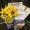 Sunflowers in a basket with caramel popcorn, nuts, and coffee toffee.