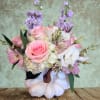 Pink and white floral arrangement in a white pumpkin vase