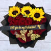 Heart-shaped bouquet of red roses topped with yellow sunflowers