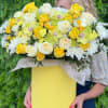 Yellow and white bouquet with roses, orchids, and daisies in a yellow box