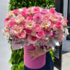 Large pink bouquet of roses and mixed blooms in a pink hatbox