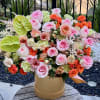 Large mixed bouquet in a gold box with pink and orange blooms