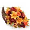 Autumn floral arrangement in a woven cornucopia basket with orange and red blooms