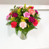 16 carnation assortment in a vase with greens and solidago.
