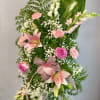 Tall floral standing spray with pink lilies, roses, and carnations
