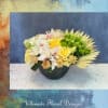 Golden Grace is a refined floral arrangement featuring creamy Candlelight Garden roses