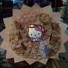 Pink rose bouquet with a Hello Kitty topper and butterfly decorations