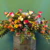Large mixed bouquet with pink roses, yellow blooms, and orange berries