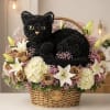 Black rose cat arrangement in a wicker basket with lilies and pink filler flowers