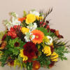 A festive autumn arrangement filled with an array of flowers including gerberas