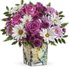 Pink roses and white daisies arranged in a decorative vase