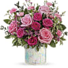 Pink and magenta roses in a clear vase