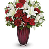 Red roses and white lilies arranged in a tall vase