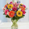 Delphinium, sunflowers, roses, lilies, gerberas, all bright and beautiful in this fun