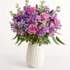 This white teardrop grooved vase is eye pleasing without taking away from