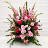Large pink and red floral arrangement with roses and tall spikes