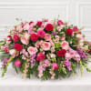 Large pink and red floral arrangement with roses and carnations