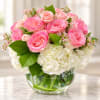 Pink roses and white hydrangeas in a clear glass vase