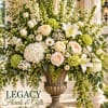 Large white and peach floral arrangement in an ornate urn vase