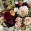 Mixed bouquet of roses, dahlias, and white blooms in pink, burgundy, and cream