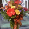 Orange Gerberas, Snap Dragon, Rust colored Calla Lillies, Yellow Roses,
Purple Monte, Red