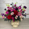 Mixed pink, red, and purple flowers in a skull-shaped vase
