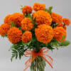 Orange marigold bouquet in a clear glass vase with an orange ribbon