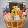 Gift basket with mugs, candle, soap, and a small faux plant