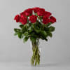 A stunning bouquet of half dozen vibrant red roses, elegantly arranged with