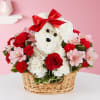 White teddy bear in a flower basket with red and pink flowers
