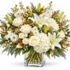 White roses and lilies in a clear glass vase with gold accents