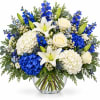 Blue and white floral arrangement in a clear glass vase
