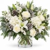 A sophisticated winter arrangement featuring white roses, lilies and hydrangeas accented with